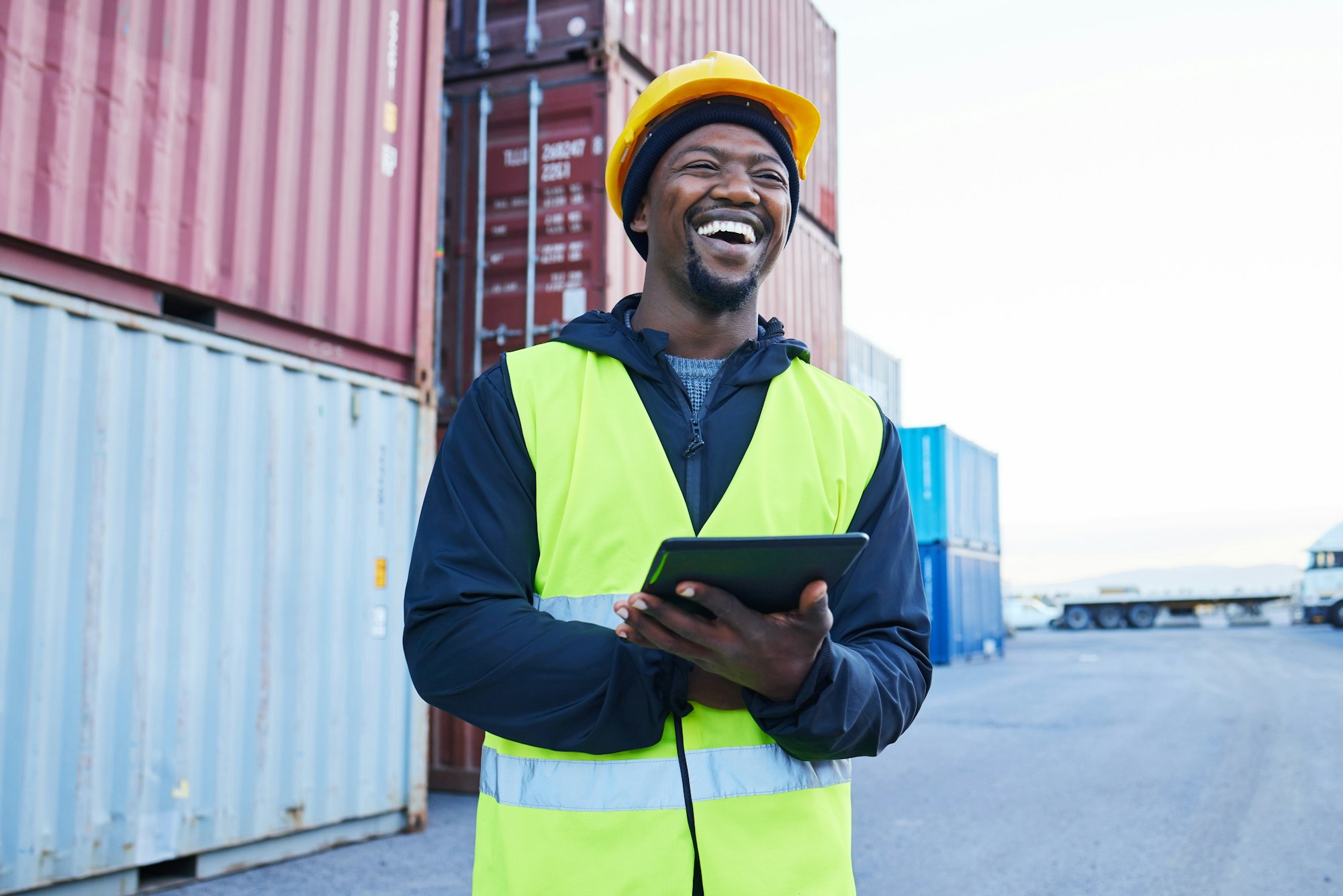 Logistics, tablet and black man planning shipping of container with stock on technology at a port.